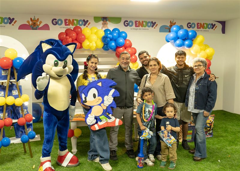 Familia posando con el personaje de Sonic y la animadora en una fiesta infantil